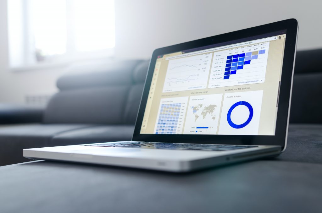 a grey laptop displaying a variety of performance charts and diagrams, representing the importance of document automation in company success