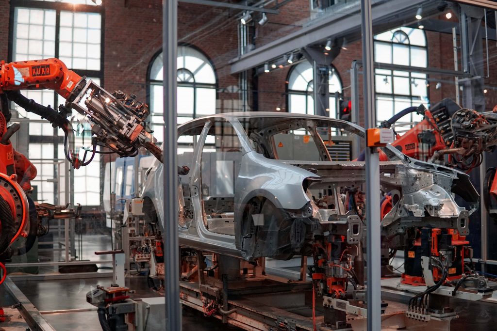 A car being manufactured by robotic machine arms