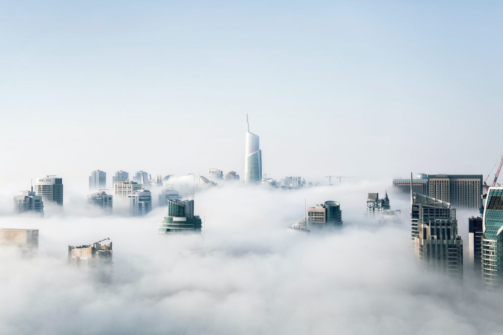 A city skyline covered in clouds 