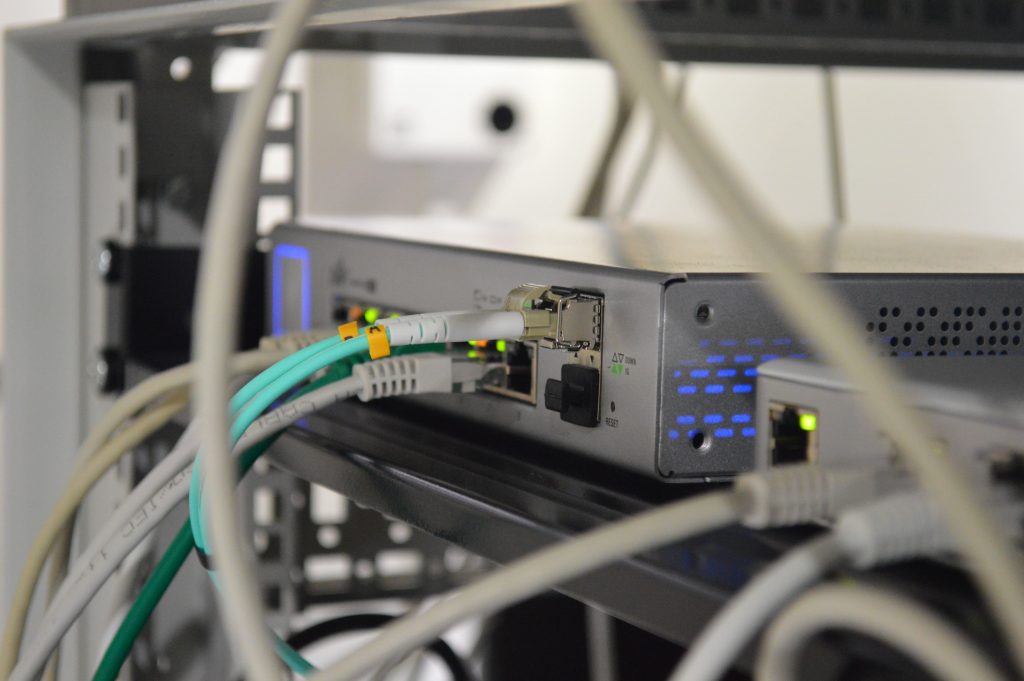 A back view of modem routers with connected ethernet cables 